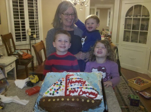 Elizabeth with her Grandchildren at birthday party with cake